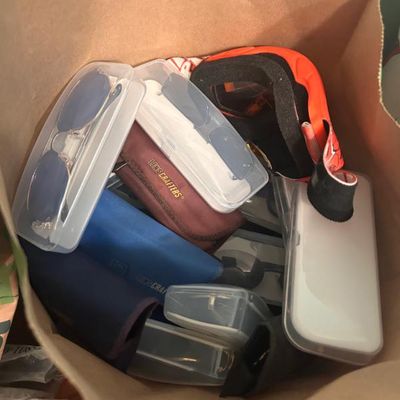 Sale Photo Thumbnail #80: Assortment of eyewear including sunglasses, ski goggles, and various protective cases from brands like LensCrafters.