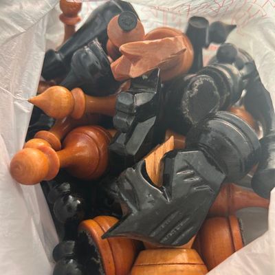Sale Photo Thumbnail #111: Collection of vintage wooden chess pieces in natural and black finishes.