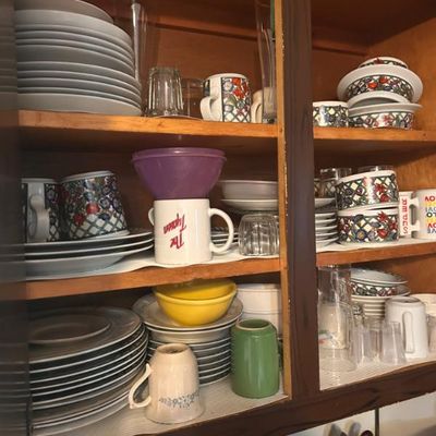 Sale Photo Thumbnail #45: Assorted everyday dinnerware, including ceramic plates, bowls, mugs with floral and novelty designs, and various drinking glasses.