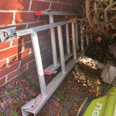 Sale Photo Thumbnail #103: Aluminum extension ladder with red end caps.