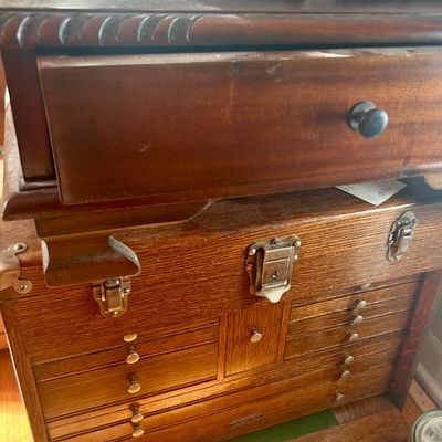 Sale Photo Thumbnail #67: Vintage Gerstner oak machinist tool chest with multiple drawers and metal latches, shown beneath a dark wood drawer unit.