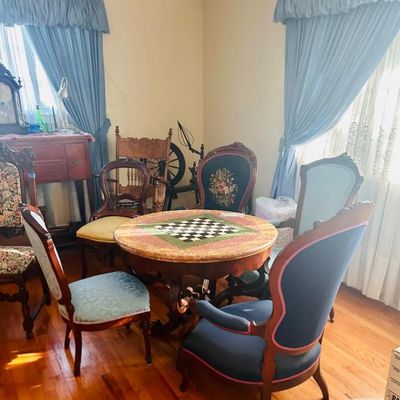 Sale Photo Thumbnail #52: Victorian-style game table with an inlaid marble chessboard top, surrounded by an assortment of upholstered parlor chairs.