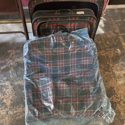 Sale Photo Thumbnail #117: Vintage three-piece luggage set featuring a classic red, green, and black plaid pattern.