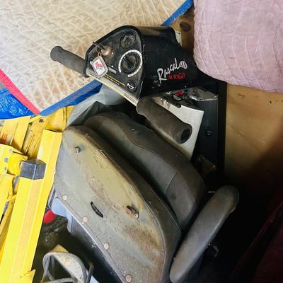 Sale Photo Thumbnail #106: Rascal AutoGo mobility scooter featuring a black control panel with key and a grey padded seat.