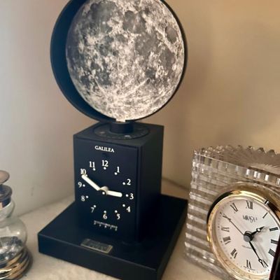 Sale Photo Thumbnail #87: Galilea moon phase clock by Sculptures Jeux Paris, featuring a black base and a rotating lunar globe.