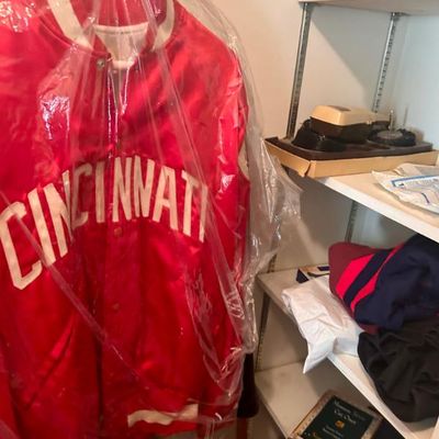 Sale Photo Thumbnail #19: Vintage red satin Cincinnati varsity jacket with white lettering, protected in a clear garment bag.