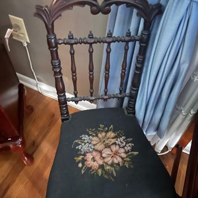 Sale Photo Thumbnail #33: Victorian-style carved wood side chair featuring a spindle back and a needlepoint seat with a floral design.