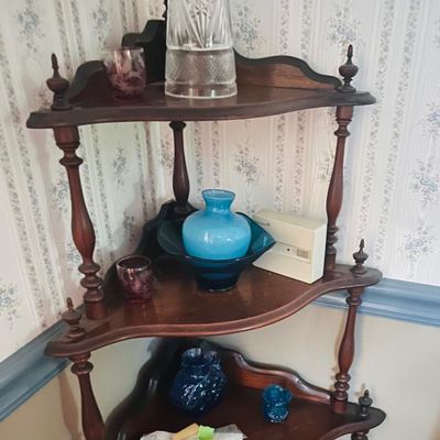 Sale Photo Thumbnail #39: Vintage wooden three-tier corner shelf featuring turned spindles and decorative finials, displaying various glassware pieces.