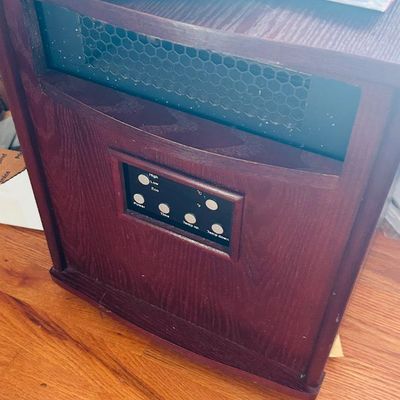 Sale Photo Thumbnail #61: Portable infrared space heater housed in a dark wood cabinet with a digital control panel.
