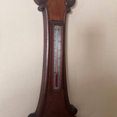 Sale Photo Thumbnail #112: Vintage wooden banjo barometer featuring a built-in thermometer with a red liquid column.