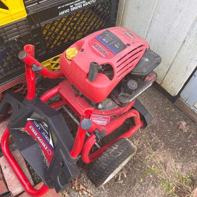Sale Photo Thumbnail #27: Troy-Bilt gas-powered pressure washer featuring a Briggs & Stratton 550 Series 158cc engine on a red wheeled frame.