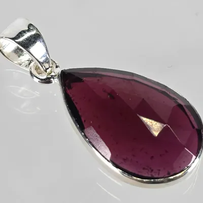 Faceted teardrop-shaped purple gemstone pendant set in a sterling silver bezel with a polished bail.