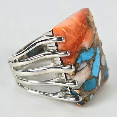 Southwestern-style sterling silver ring featuring a multi-stone mosaic inlay of spiny oyster shell, turquoise, and mother of pearl,...
