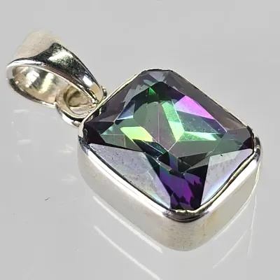 Sterling silver pendant featuring a rectangular, emerald-cut mystic topaz gemstone with vibrant green and purple iridescence.