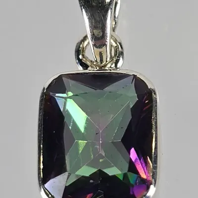 Sterling silver pendant featuring a rectangular, emerald-cut mystic topaz stone with vibrant green and purple iridescence.