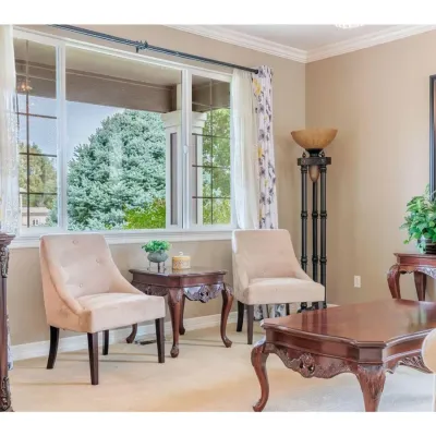 Traditional living room furniture set including a pair of tufted beige accent chairs, a carved wood coffee table, a matching side table,...