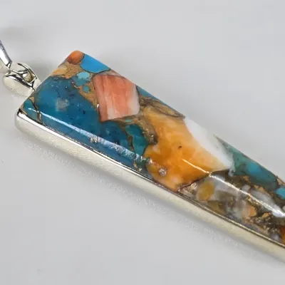 Sterling silver pendant featuring a long, rectangular multi-stone inlay of turquoise, spiny oyster shell, and other colorful minerals.