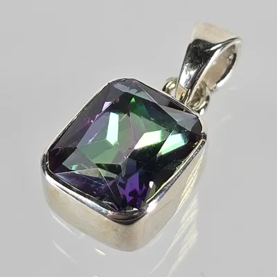 Sterling silver pendant featuring a rectangular, step-cut mystic topaz stone with vibrant green and purple iridescence.