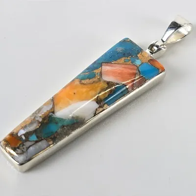 Rectangular sterling silver pendant featuring a colorful mosaic inlay of turquoise, spiny oyster shell, and copper matrix.