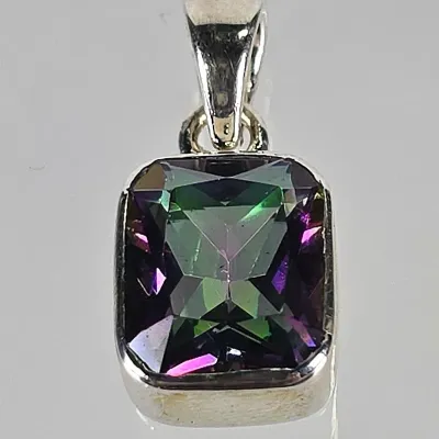 Sterling silver pendant featuring a rectangular, step-cut mystic topaz gemstone with vibrant green and purple iridescence.