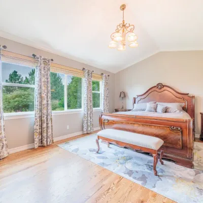 Traditional style bedroom set featuring a carved wooden sleigh bed, matching nightstand, and an upholstered bench, complemented by a...