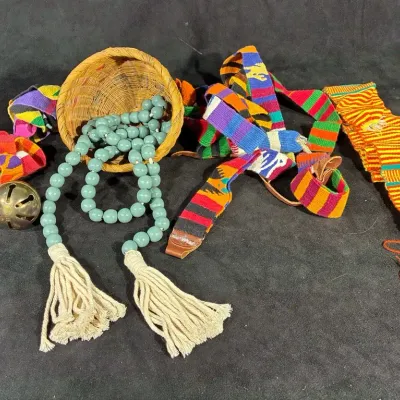 Strand Of Wooden Beads And Colorful Cloth Belts
