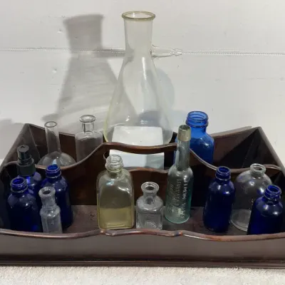 An Assortment of Glass Bottles & A Wood Caddy