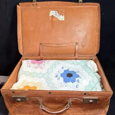 Grandmother's Flower Garden patchwork quilt & Leather Suitcase