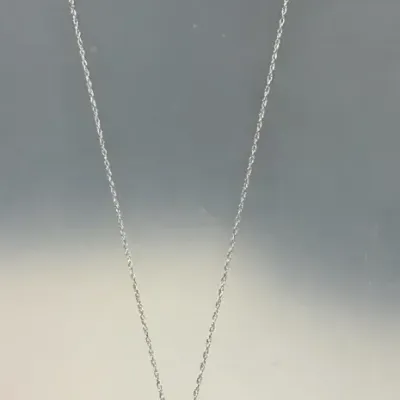 14k white gold teardrop pendant necklace adorned with a delicate pave diamond halo