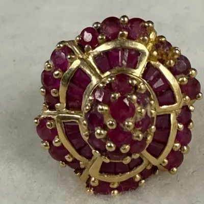 vintage 10k yellow gold cocktail ring features a distinct, multi-tiered ruby cluster design