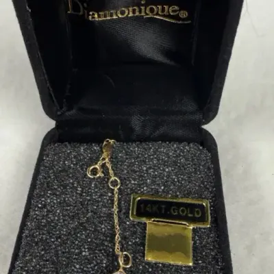 14k delicate gold-tone necklace extender featuring a bezel-set clear crystal charm at the end.