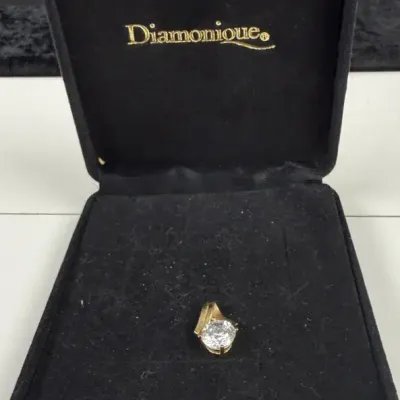 14k Tormeline gold pendant featuring a large, colorless round-cut gemstone