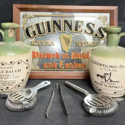 Vintage Irish Whiskey Ceramic Crocks, a Guinness Mirror Sign, and Classic Barware Accessories