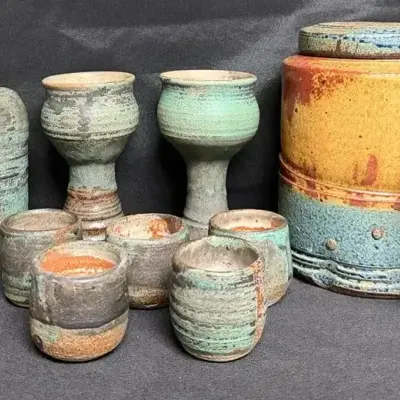 Handmade Stoneware Features a Striking Mix of Textured Teal, Rust, and Warm Ochre Glazes 