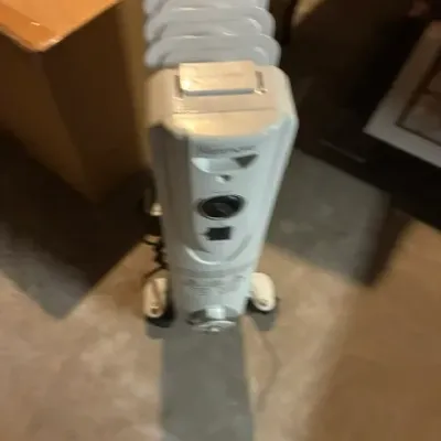 Kenmore portable oil-filled radiator heater on wheels, showing some light wear from use.