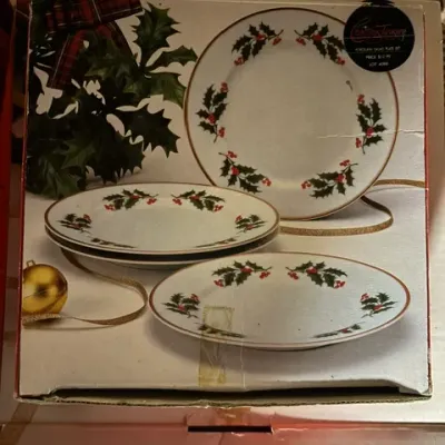 Christmas Treasury porcelain salad plate set in its original box, featuring a festive holly and berry design with gold-toned rims.