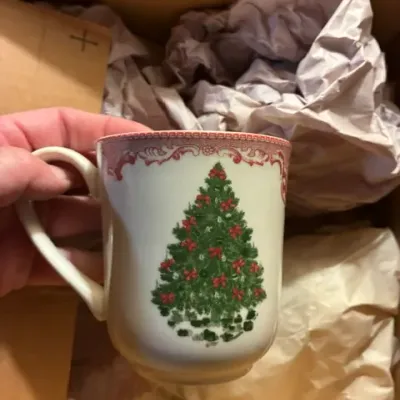 Spode Christmas Tree pattern ceramic mug, featuring the classic decorated evergreen design with a red scrollwork border.
