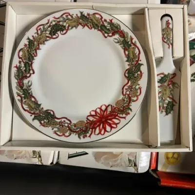 Mikasa holiday-themed cake plate and server set, featuring a festive holly and red ribbon design in its original packaging.