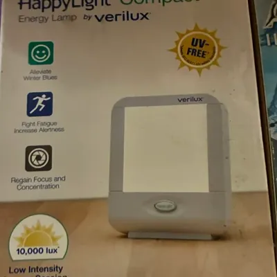 Verilux HappyLight Compact energy lamp in its original retail packaging, designed for light therapy.