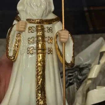 Lenox porcelain Father Christmas figurine in a white hooded robe with gold-gilded trim, holding a staff.