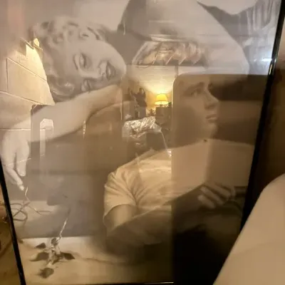 Large framed black and white poster featuring Marilyn Monroe and James Dean, housed in a simple black metal frame.