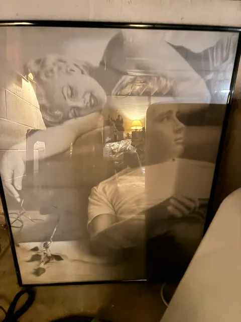 Large framed black and white poster featuring Marilyn Monroe and James Dean, housed in a simple black metal frame.