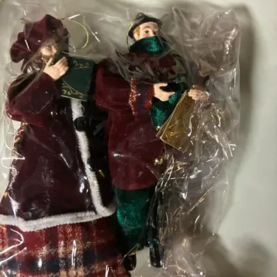 Pair of Victorian-style Christmas carolers ornaments, featuring fabric clothing and hand-painted details, sealed in original plastic...
