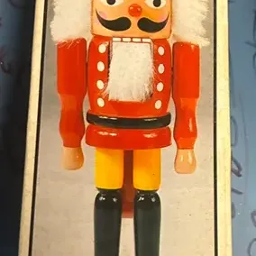Vintage Sears wooden soldier nutcracker in its original box, featuring a classic red, yellow, and black painted design with white faux...