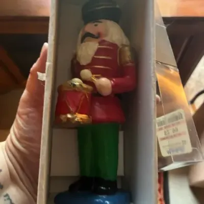 Vintage nutcracker drummer figurine in its original packaging, featuring a red jacket, green pants, and a small drum.