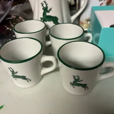 Vintage white ceramic coffee pot and matching mug set featuring a green stag motif and green trim.