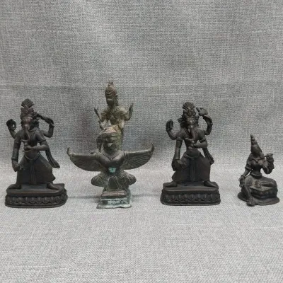 Four Brass Hindu Deity Figures: Two Dancing Ganesha, Vishnu on Garuda, Seated Goddess