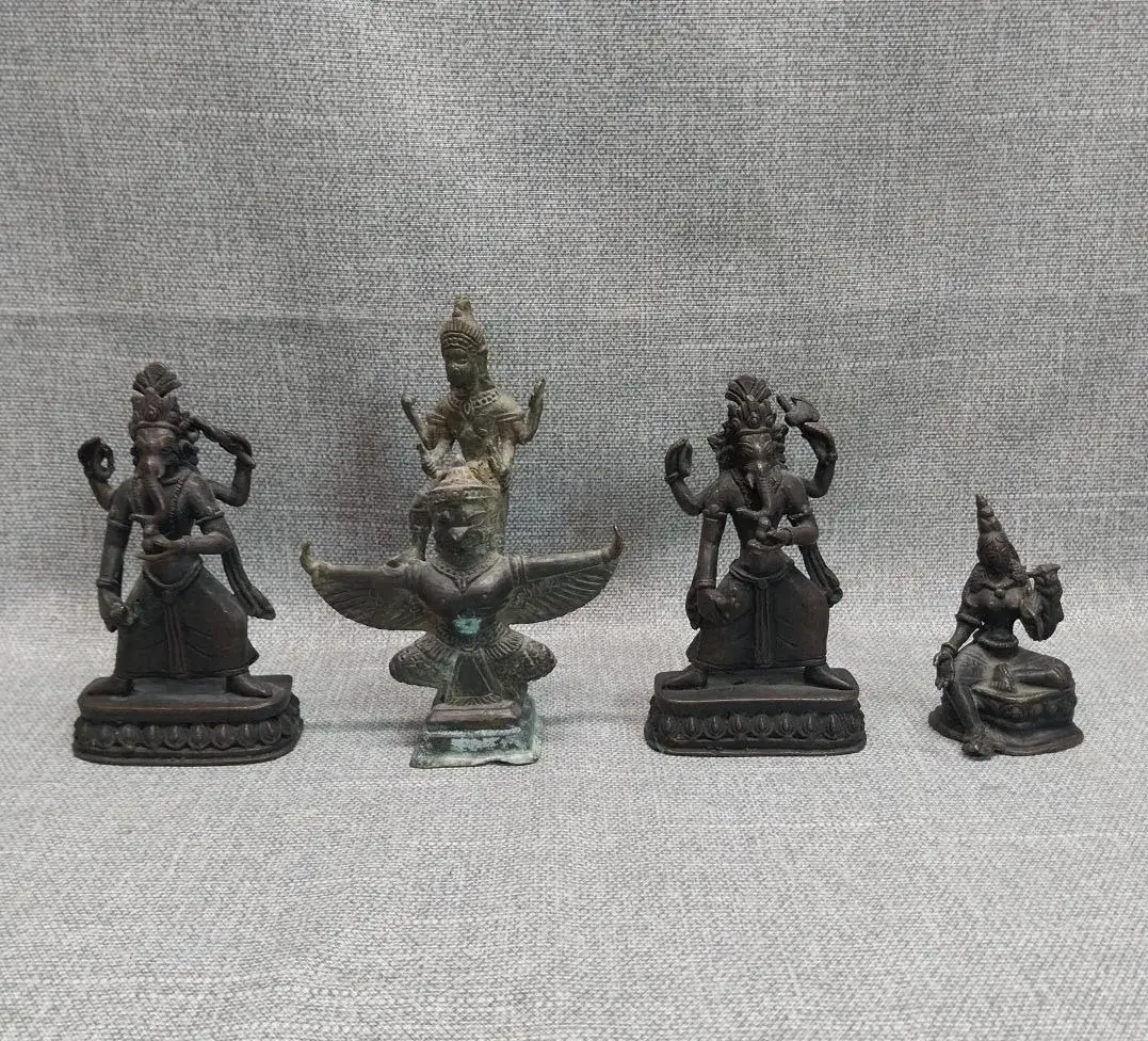 Four Brass Hindu Deity Figures: Two Dancing Ganesha, Vishnu on Garuda, Seated Goddess