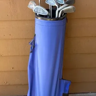 Golf Clubs With A Blue Carry Bag