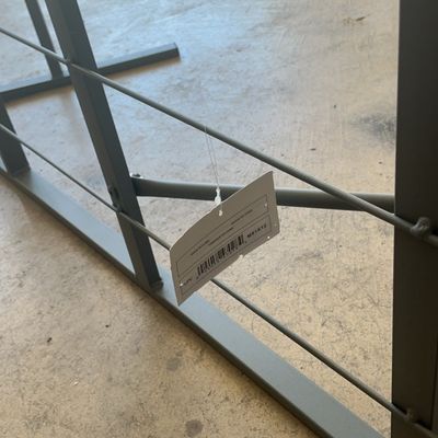 Modern gray metal wire shelving unit with retail tag attached, showing a sturdy frame construction.